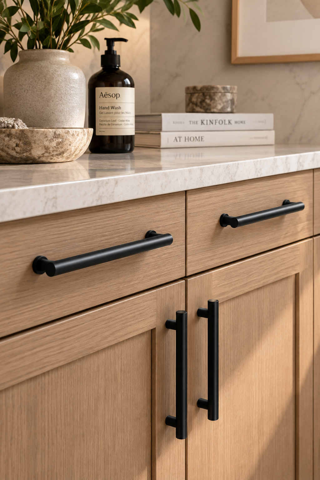 Minimalist matte black cabinet hardware on warm wood cabinets